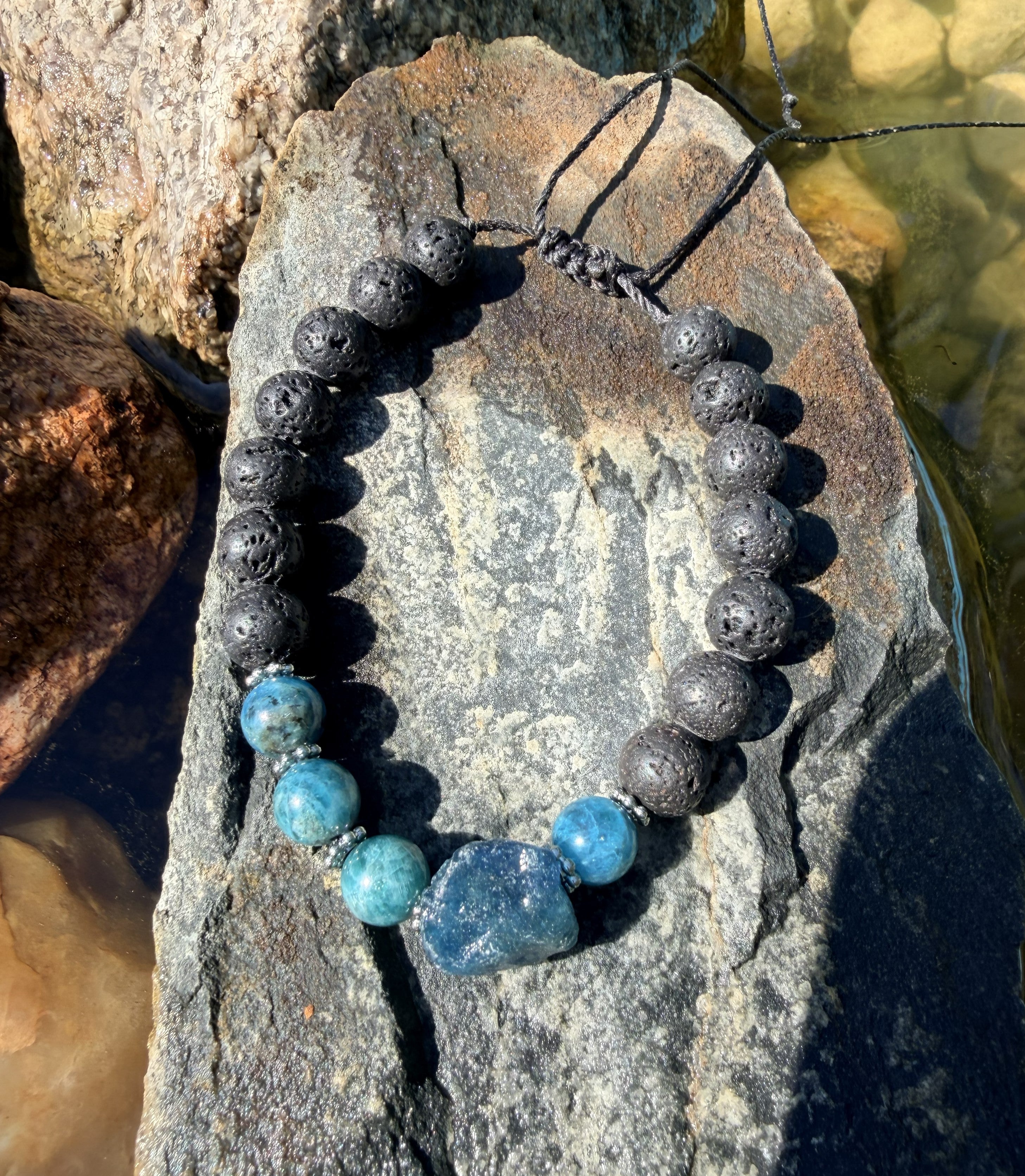 0015 - Black lava with blue apatite & roughcut blue apatite