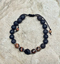 0046 - Black lava with red snowflake obsidian & roughcut spinel